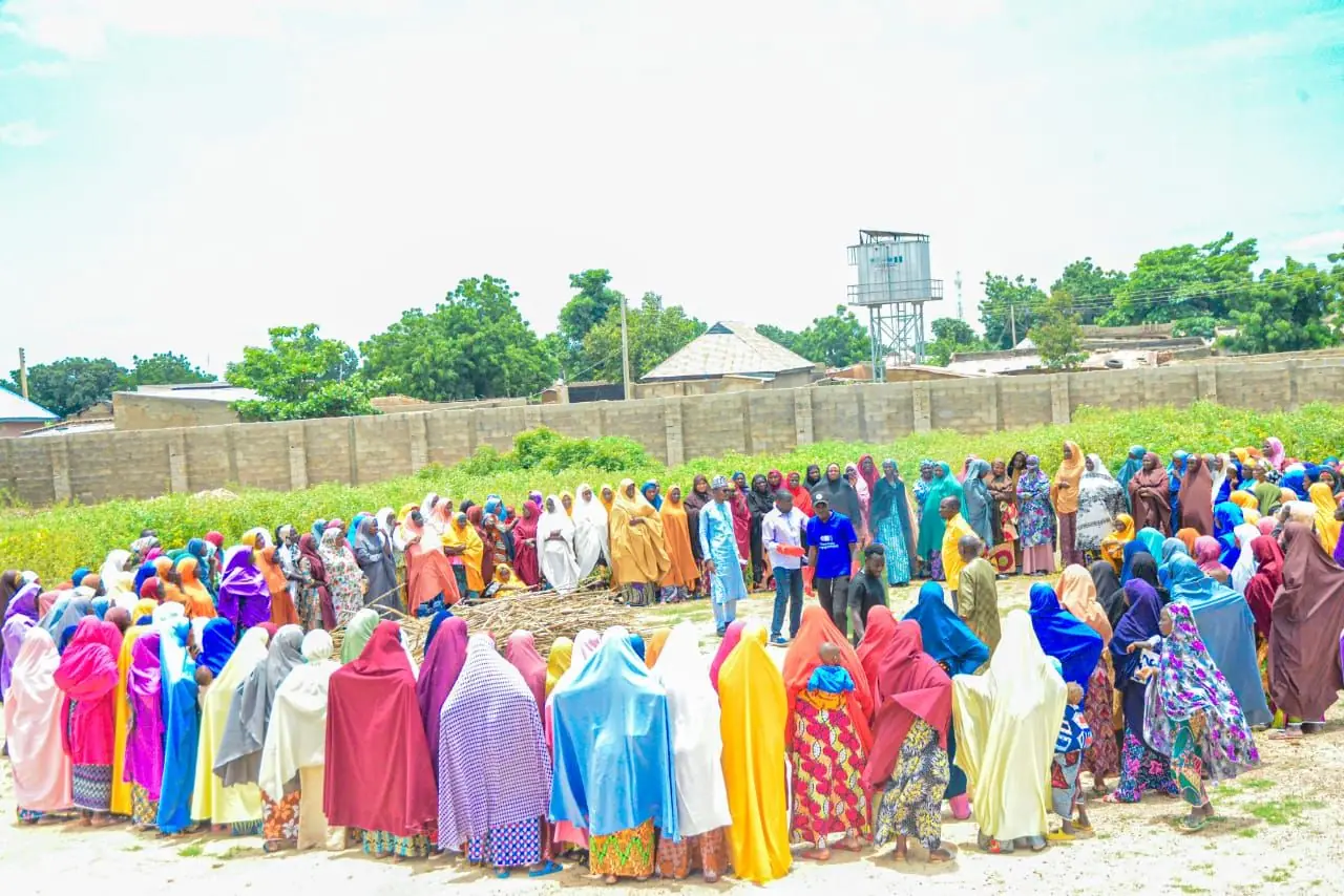 Several hundred community members, mostly women, gathered around a Biochar Solutions Africa field demonstration
